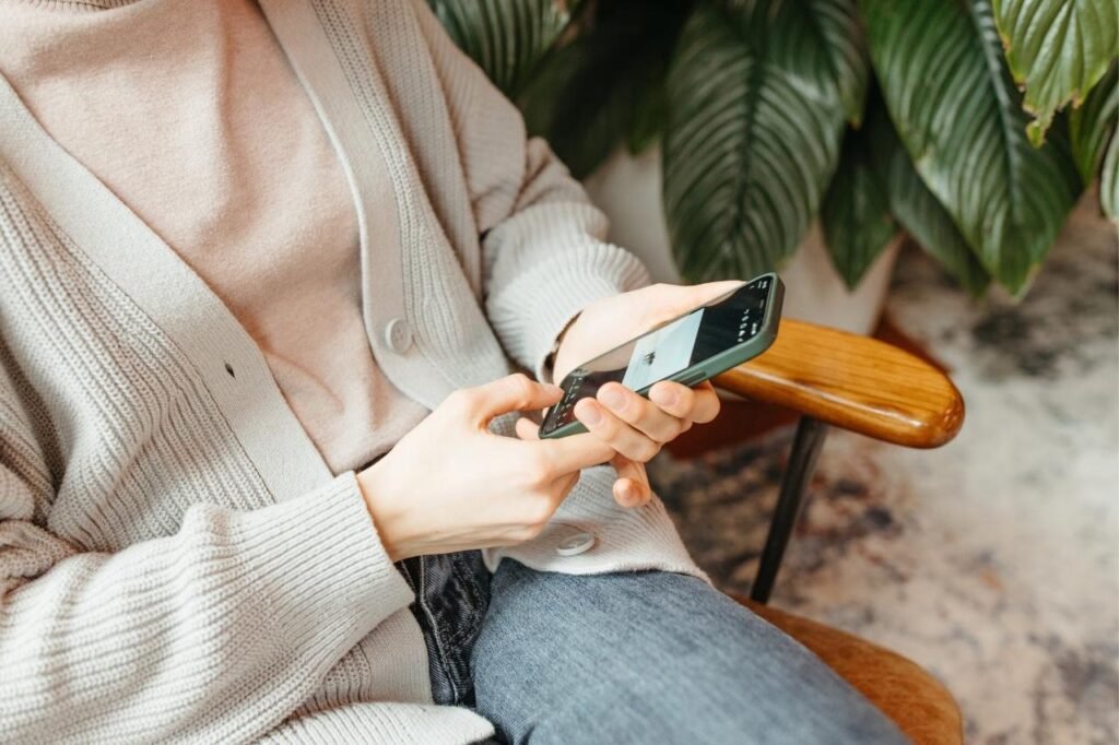 Women sitting on chair and using mobile phone